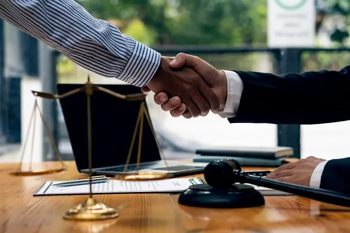 handshake between lawyer and client